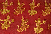 Luang Prabang, Laos - Wat Pa Phai the 'Bamboo Forest Monastery'. Inside gilded stencils against a red lacquered background depict scenes from the Buddhist hell. 